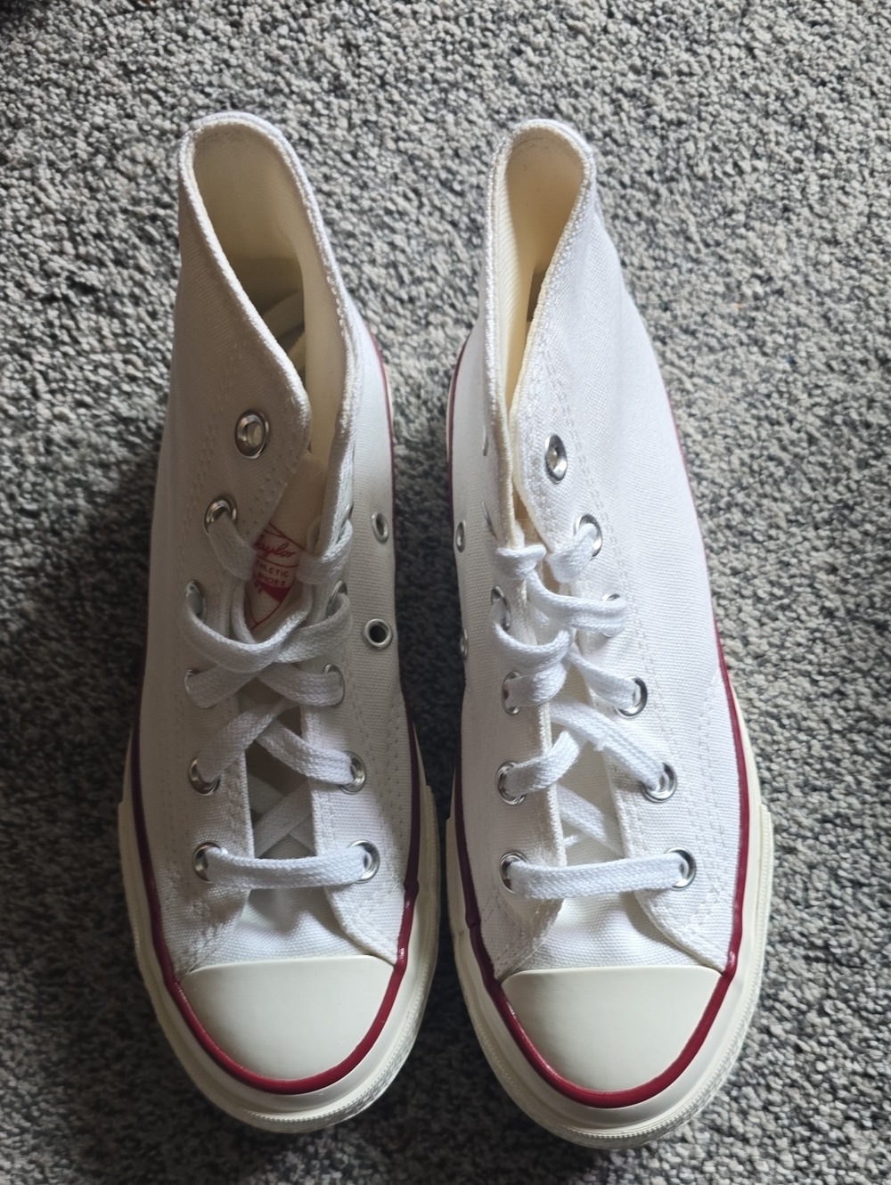 Converse White Canvas Kids High-Top Sneakers with Red Accents.